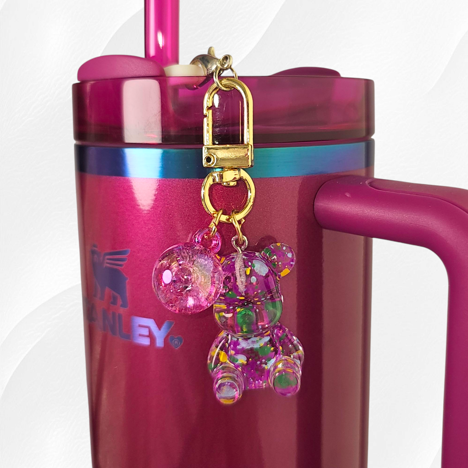 Transparent berry truffle purple teddy bear with green and yellow specks. Use as a tumbler, purse, or keychain charm. 