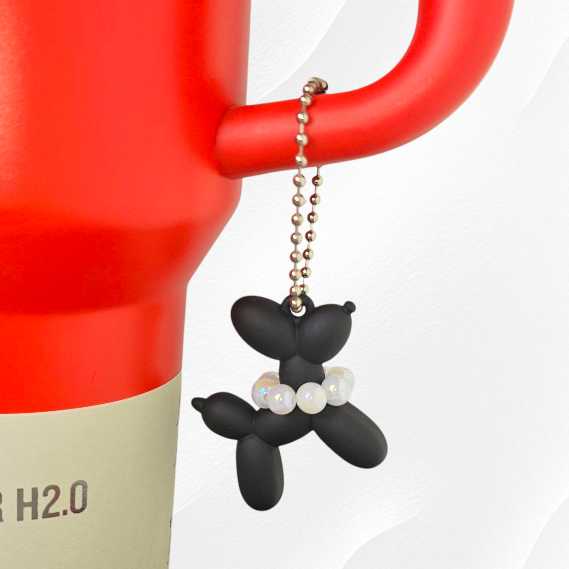Black Balloon Dog wearing white pearl necklace cup handle charm. 
