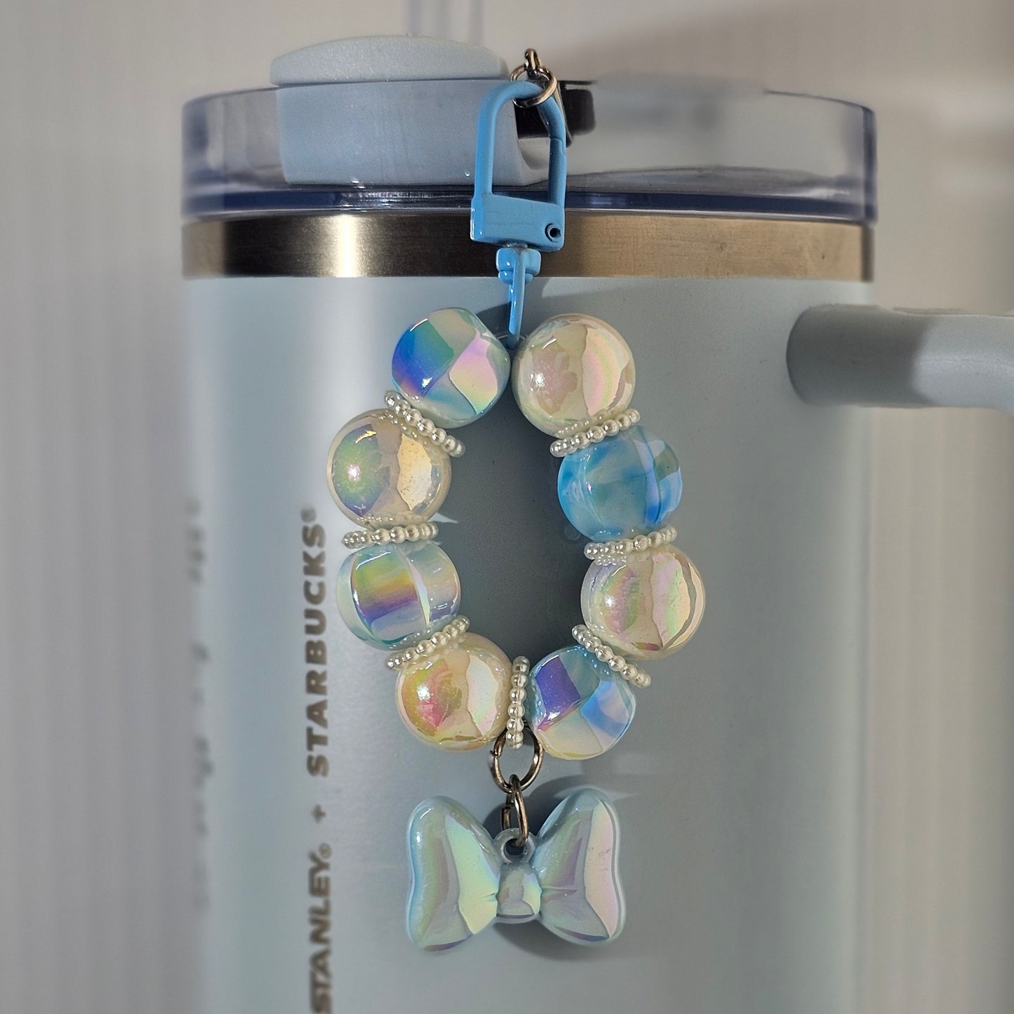 Blue  and white beaded bow tumbler straw charm. 