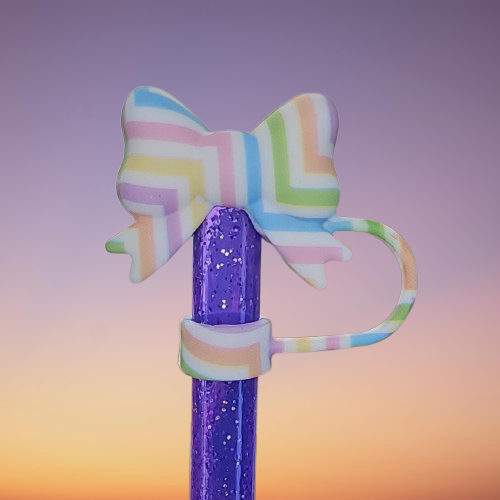 Coquette Ribbon Bow Silicone Straw Topper  - Easter Egg. Stripe colors are pink, purple, blue, green, orange, and yellow with a White background. 