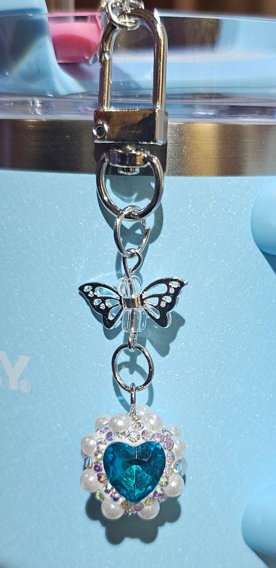 Iridescent Pearlescent Blue Heart Jewel trimmed with White Rhinestone Glitter and Silver Butterfly Charm Pendant - Southern Creative Glamour