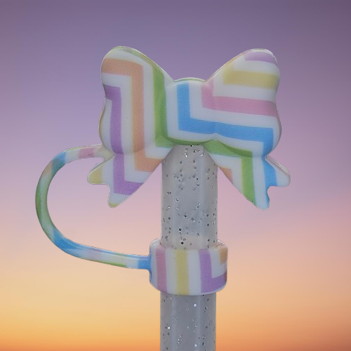 Coquette Ribbon Bow Silicone Straw Topper  - Easter Egg. Stripe colors are pink, purple, blue, green, orange, and yellow with a White background. 