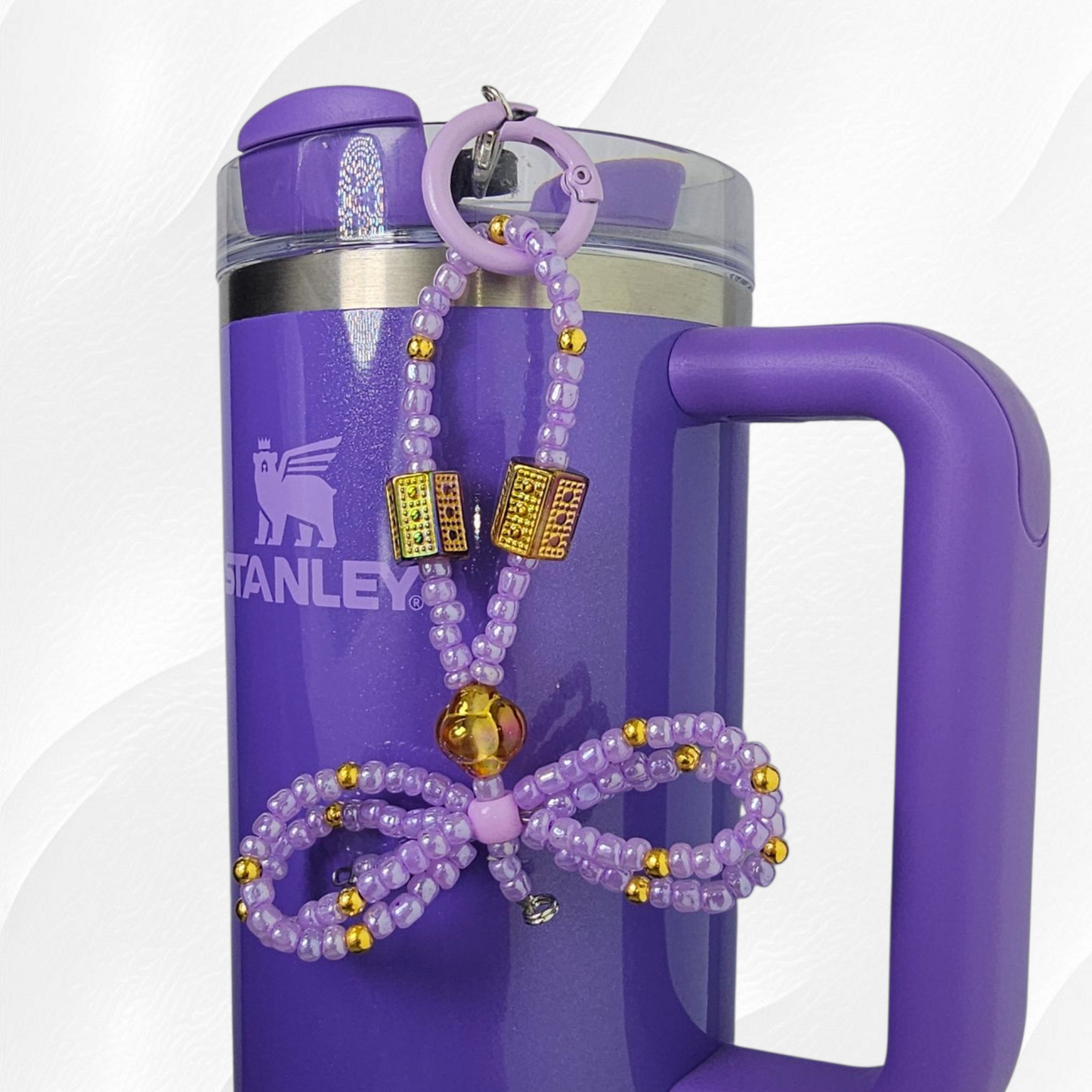 Egyptian themed purple and gold beaded ribbon bow charm. 